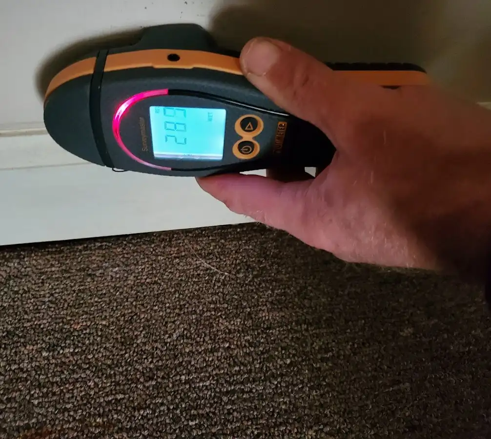 Moisture detection at baseboard during Storm Damage Restoration in Grovetown